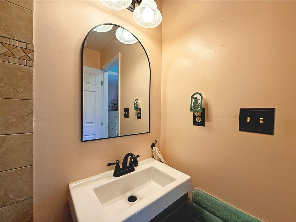 1411 Myrtle Street Fulton, TX 78358 - Photo 18 of 26 a bathroom with a sink and a mirror