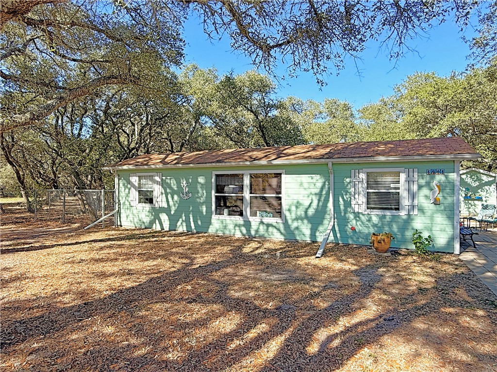 1411 Myrtle Street Fulton, TX 78358 - Photo 2 of 26 a front view of a house with a garden