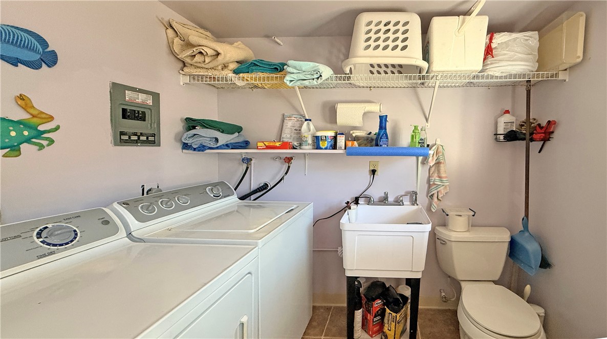 1411 Myrtle Street Fulton, TX 78358 - Photo 24 of 26 a bathroom with a sink a toilet and a mirror