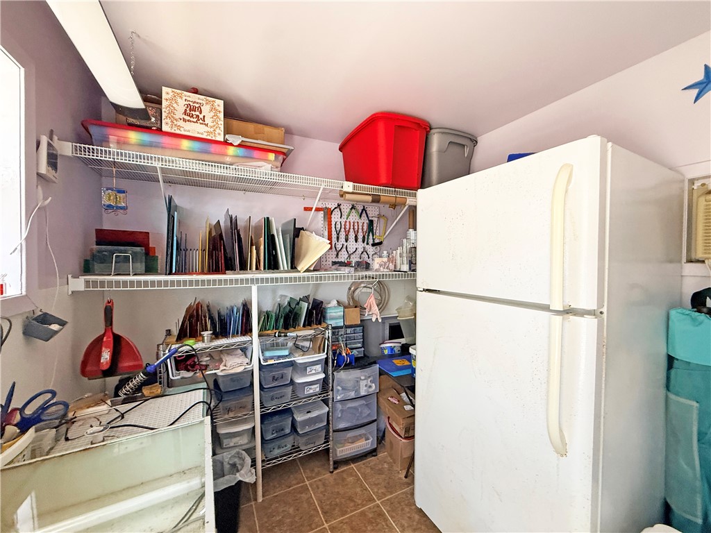 1411 Myrtle Street Fulton, TX 78358 - Photo 25 of 26 a kitchen with a refrigerator and a white stove top oven