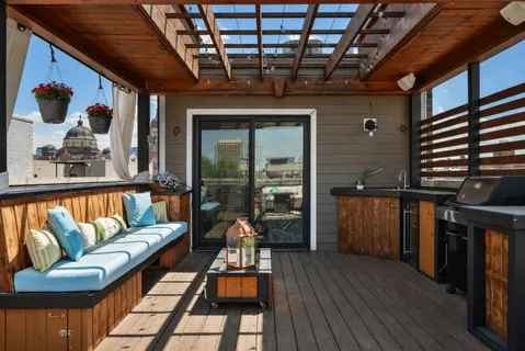a view of a porch with furniture and wooden floor