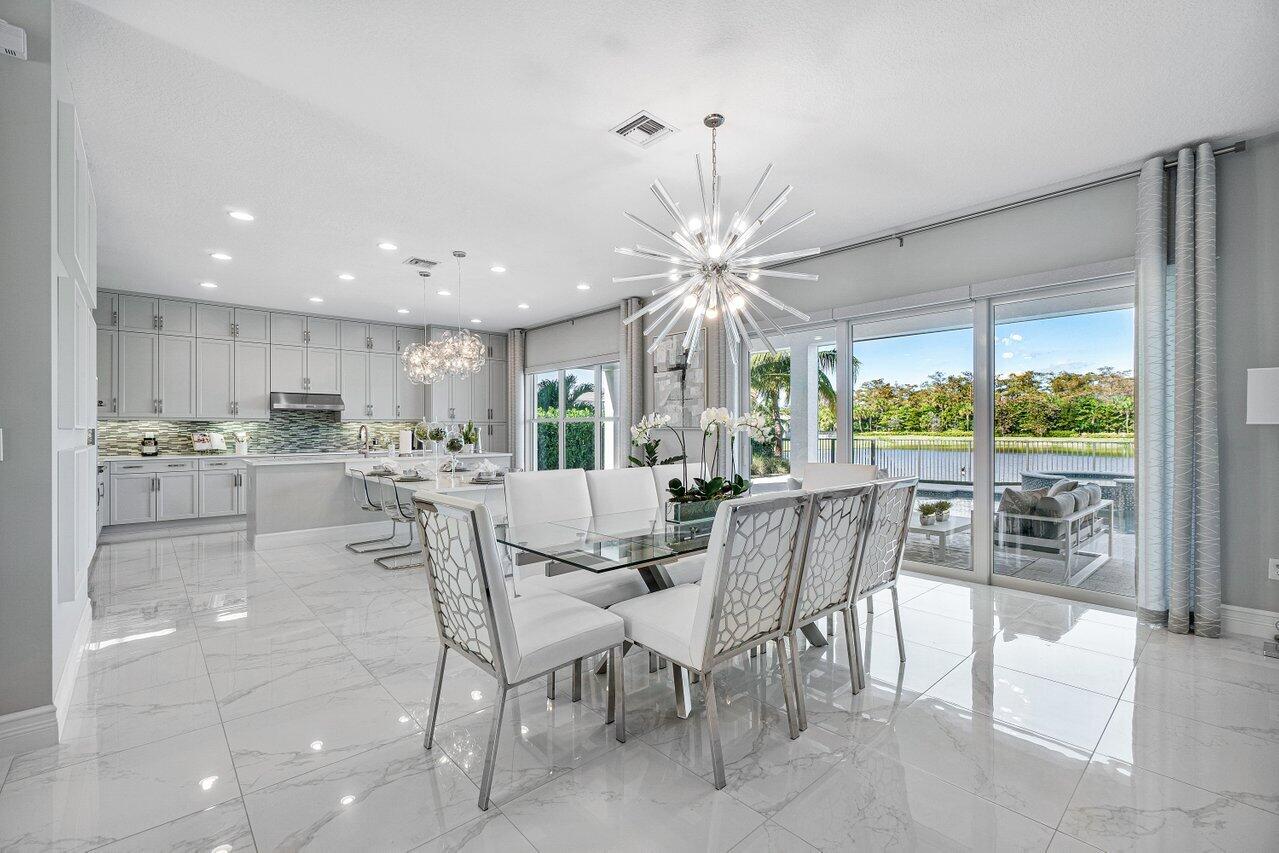 11655 Windy Frst Way Boca Raton, FL 33498 - Photo 11 of 50 a dining area with furniture and a large window