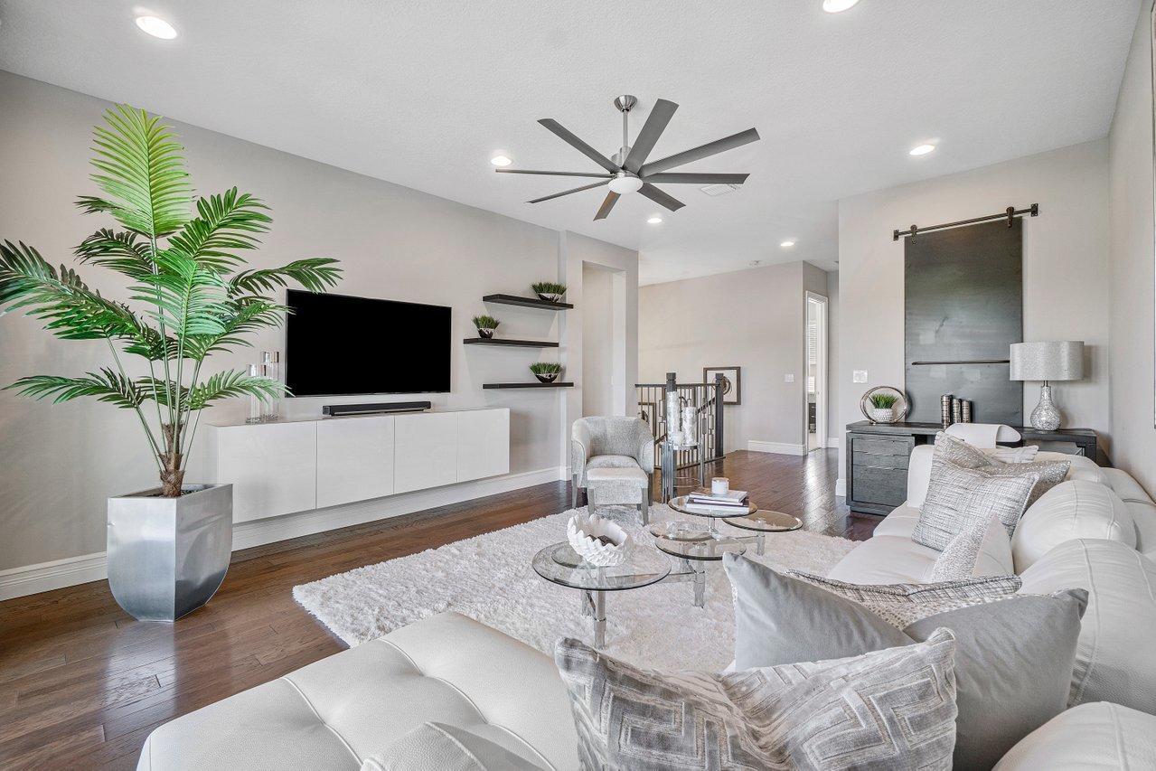 11655 Windy Frst Way Boca Raton, FL 33498 - Photo 18 of 50 a living room with furniture a fireplace and a flat screen tv