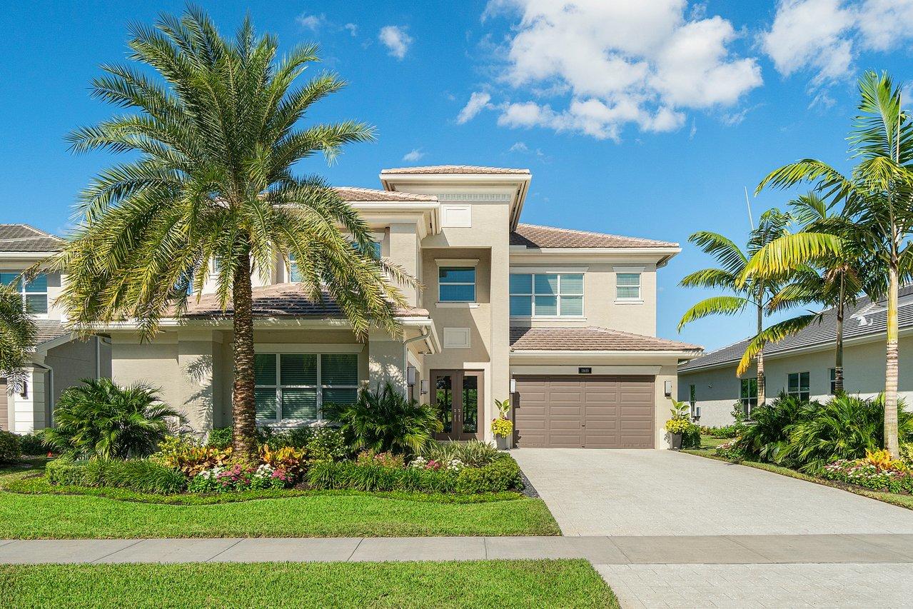 11655 Windy Frst Way Boca Raton, FL 33498 - Photo 2 of 50 a front view of a house with a garden