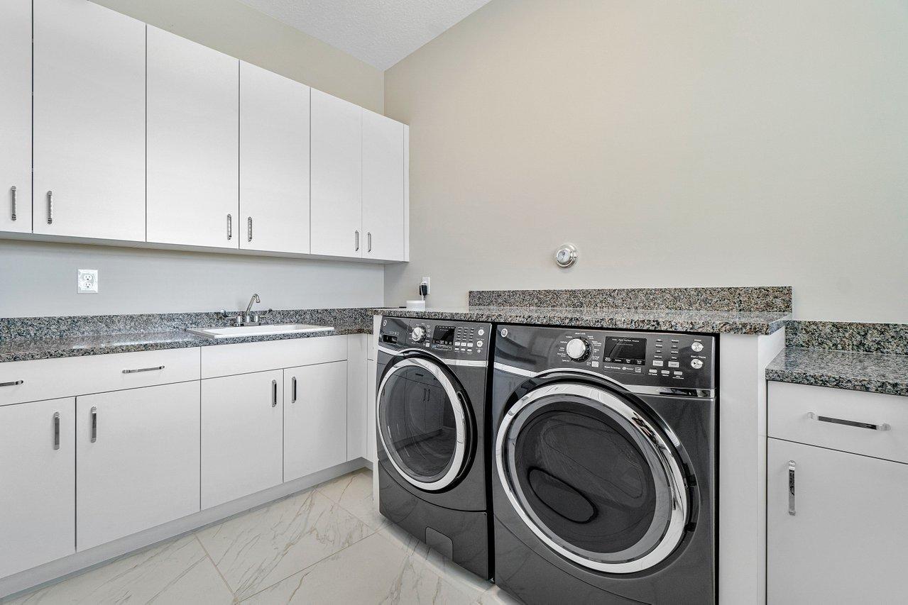 11655 Windy Frst Way Boca Raton, FL 33498 - Photo 23 of 50 a utility room with sink dryer and washer