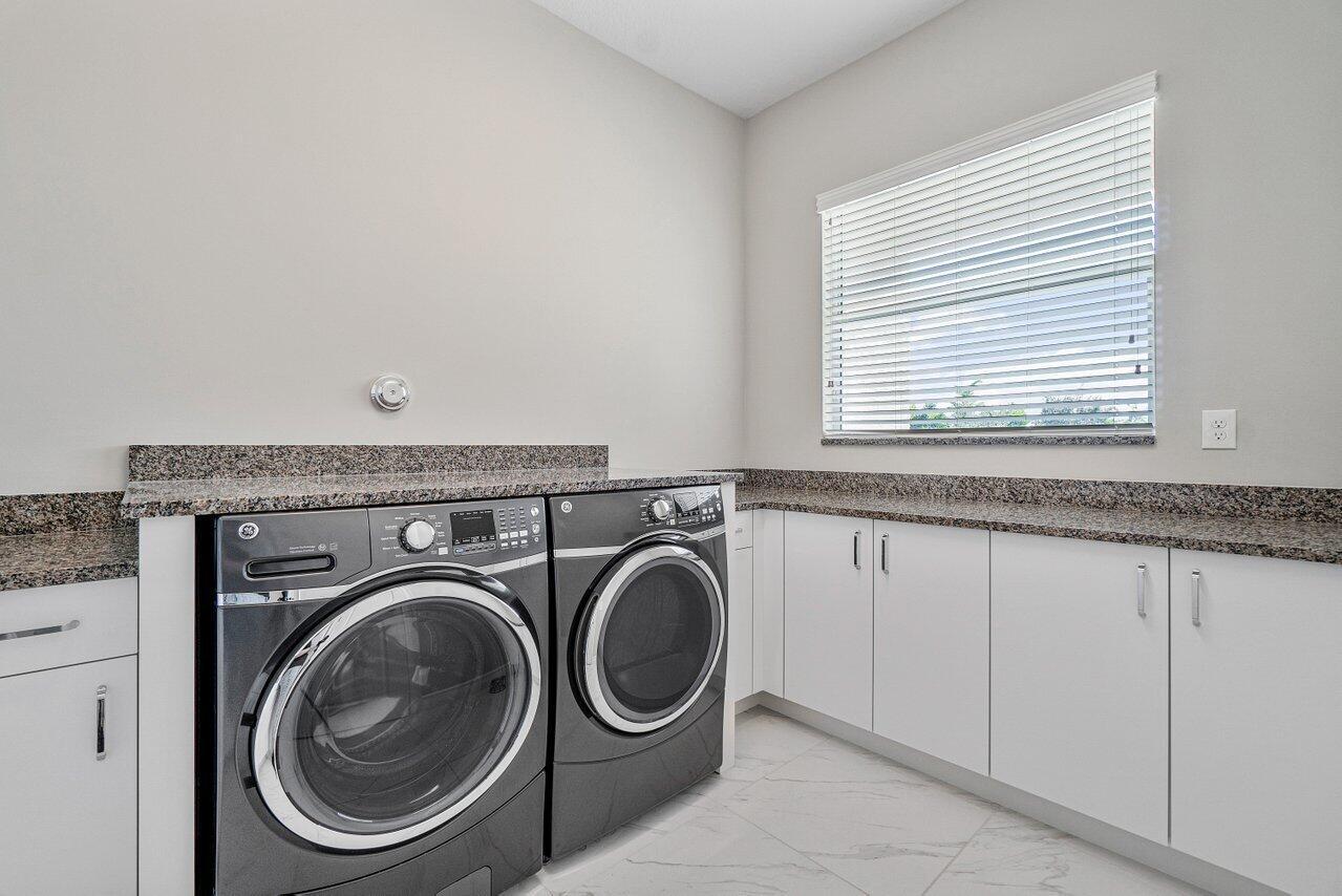 11655 Windy Frst Way Boca Raton, FL 33498 - Photo 24 of 50 a utility room with dryer and washer