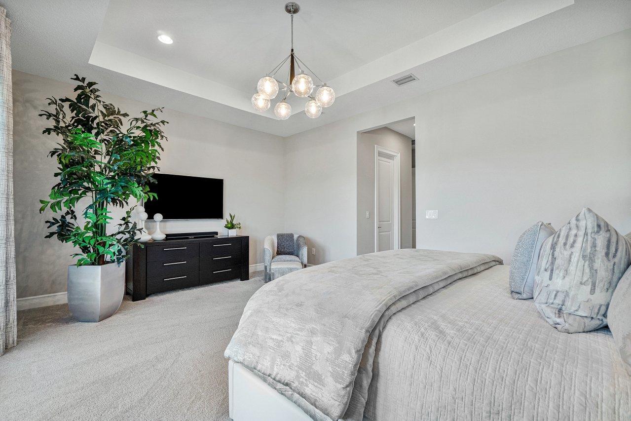 11655 Windy Frst Way Boca Raton, FL 33498 - Photo 26 of 50 a bedroom with a bed and a flat screen tv