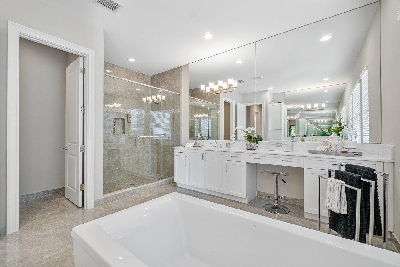 11655 Windy Frst Way Boca Raton, FL 33498 - Photo 27 of 50 a large white bathroom with a sink a large mirror and shower