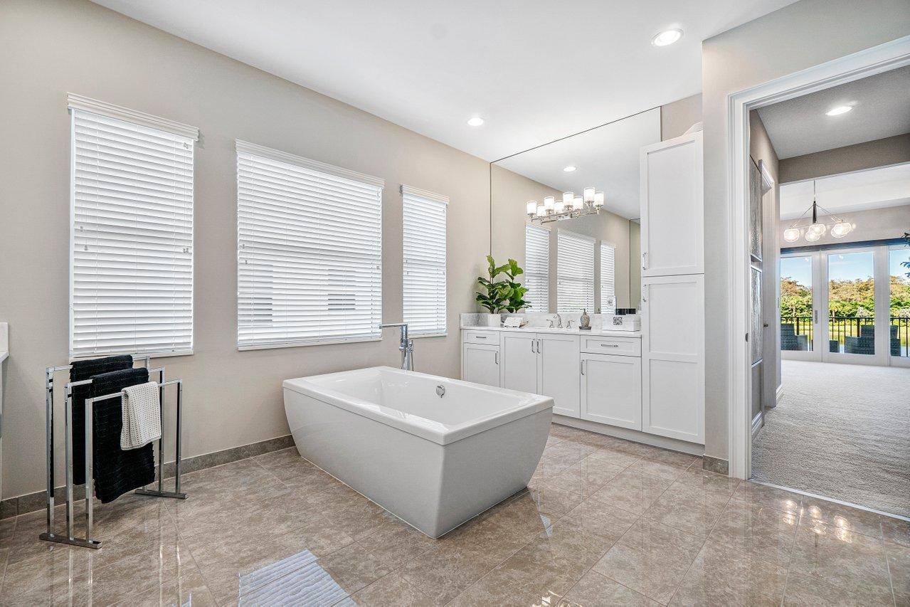 11655 Windy Frst Way Boca Raton, FL 33498 - Photo 28 of 50 a spacious bathroom with a tub a potted plant and a sink