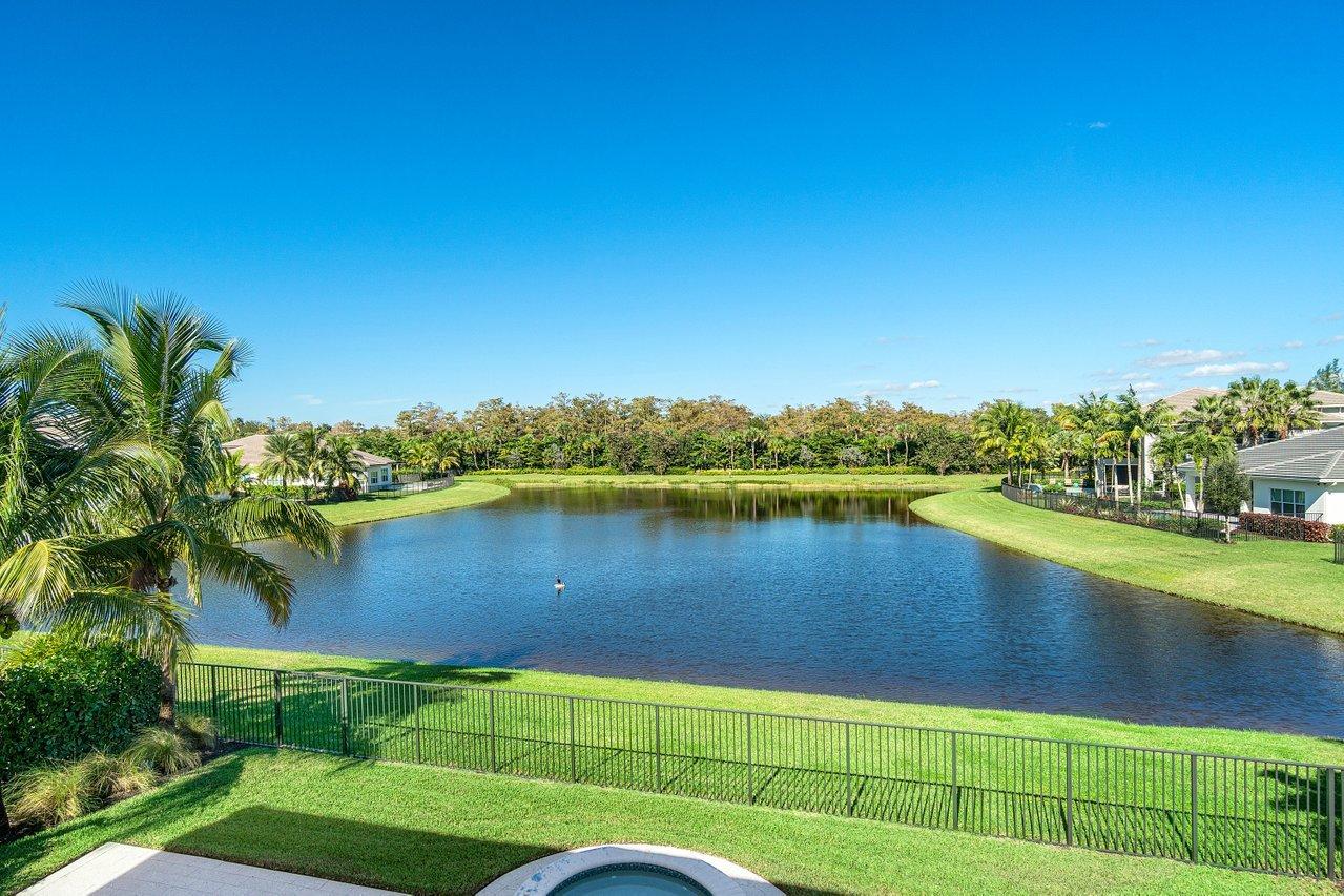 11655 Windy Frst Way Boca Raton, FL 33498 - Photo 36 of 50 a view of a lake with a house in the background