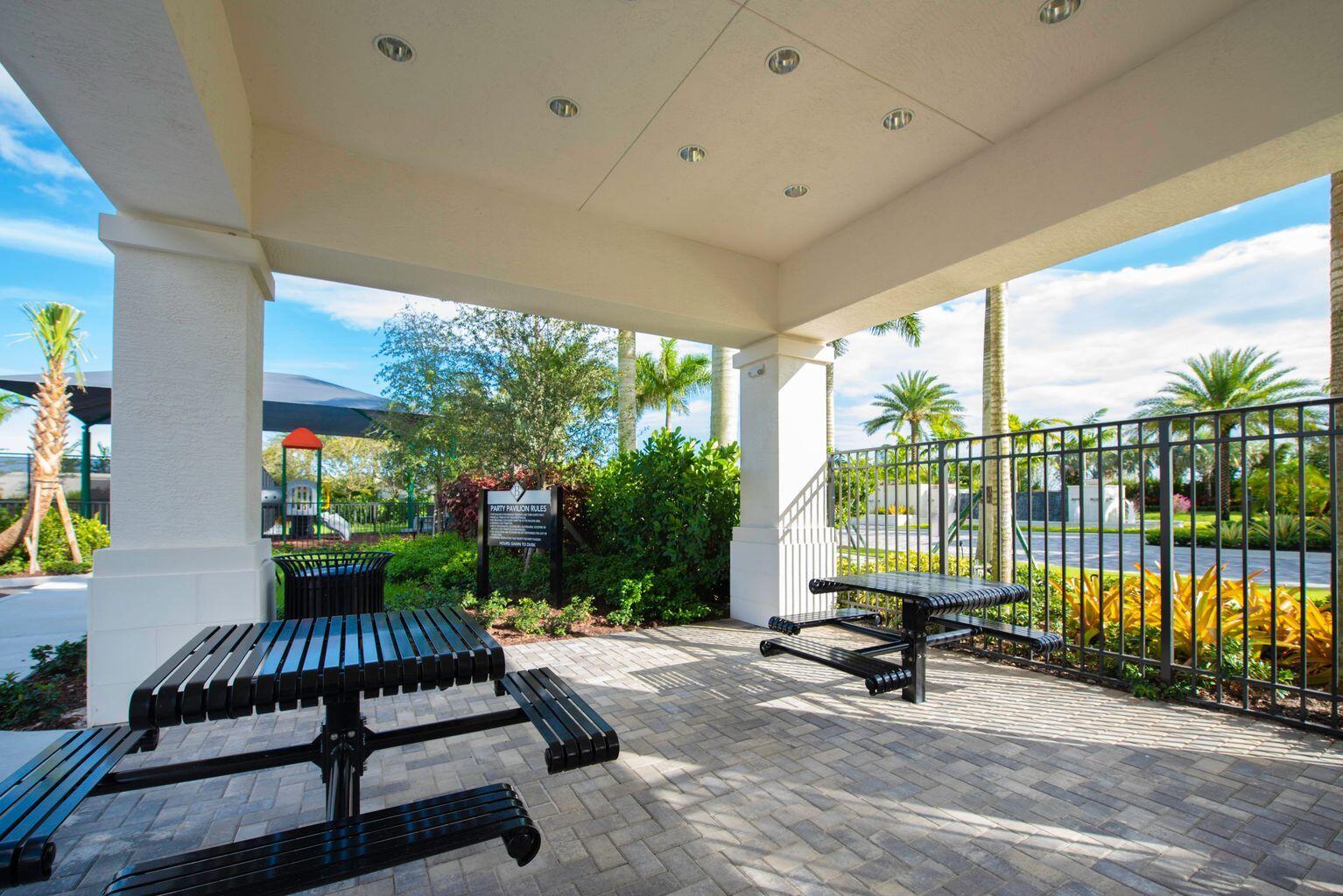 11655 Windy Frst Way Boca Raton, FL 33498 - Photo 49 of 50 a view of a patio with a table chairs and a backyard