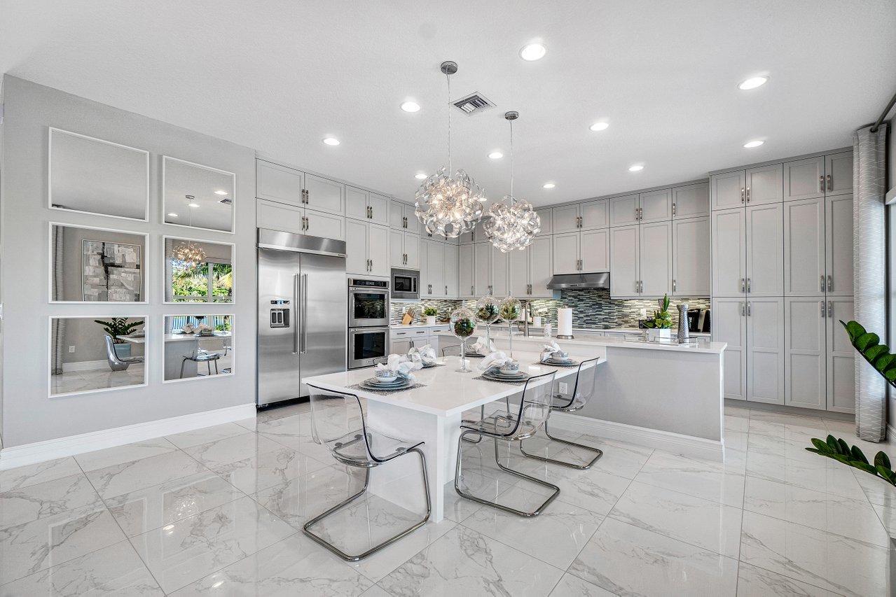 11655 Windy Frst Way Boca Raton, FL 33498 - Photo 5 of 50 a kitchen with stainless steel appliances kitchen island granite countertop a refrigerator and cabinets