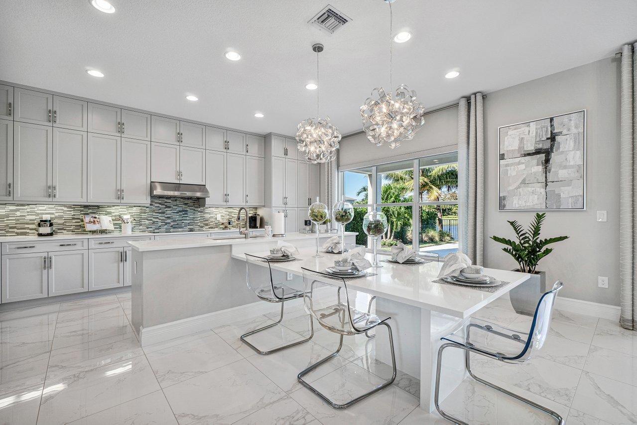 11655 Windy Frst Way Boca Raton, FL 33498 - Photo 6 of 50 a kitchen with a white table chairs window and cabinets