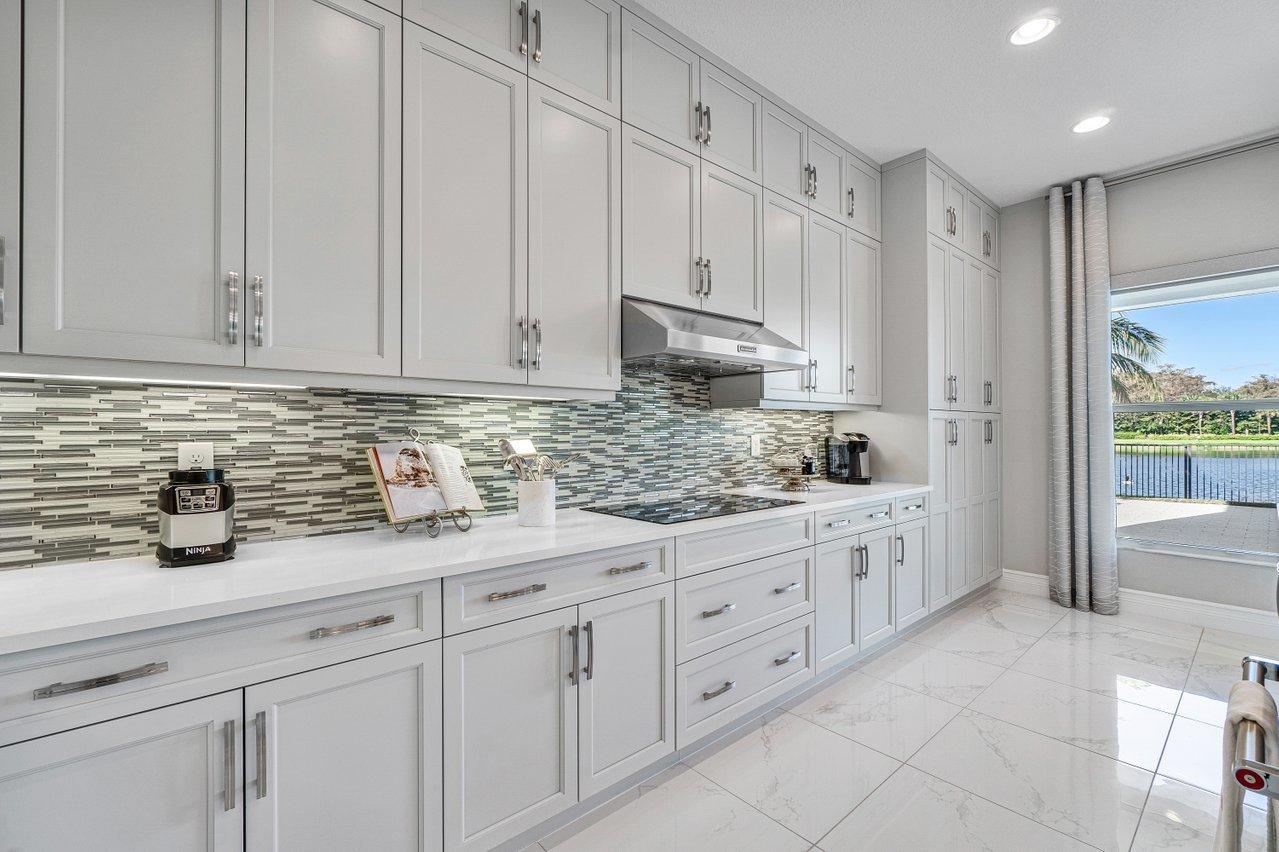 11655 Windy Frst Way Boca Raton, FL 33498 - Photo 7 of 50 a kitchen with granite countertop white cabinets and stainless steel appliances