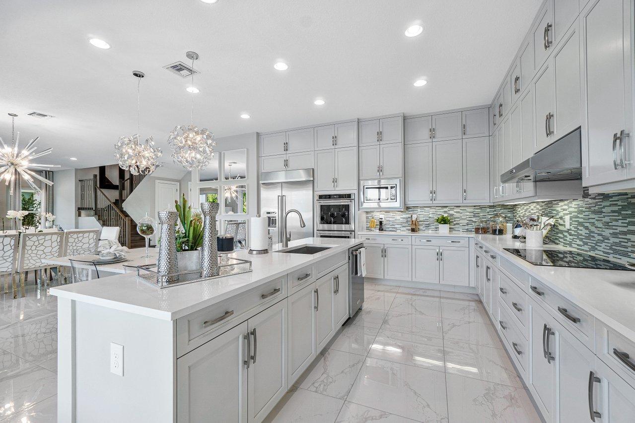 11655 Windy Frst Way Boca Raton, FL 33498 - Photo 9 of 50 a kitchen with sink stove and cabinets