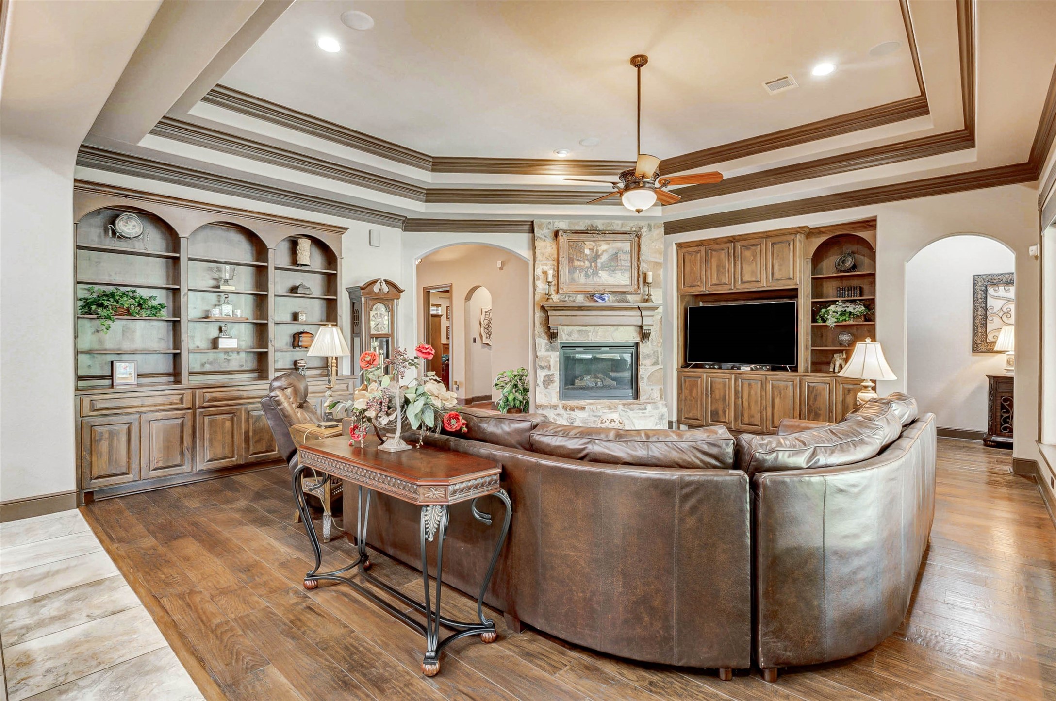 4315 Wickby Street Fulshear, TX 77441 - Photo 11 of 46 a room with fireplace furniture and a chandelier