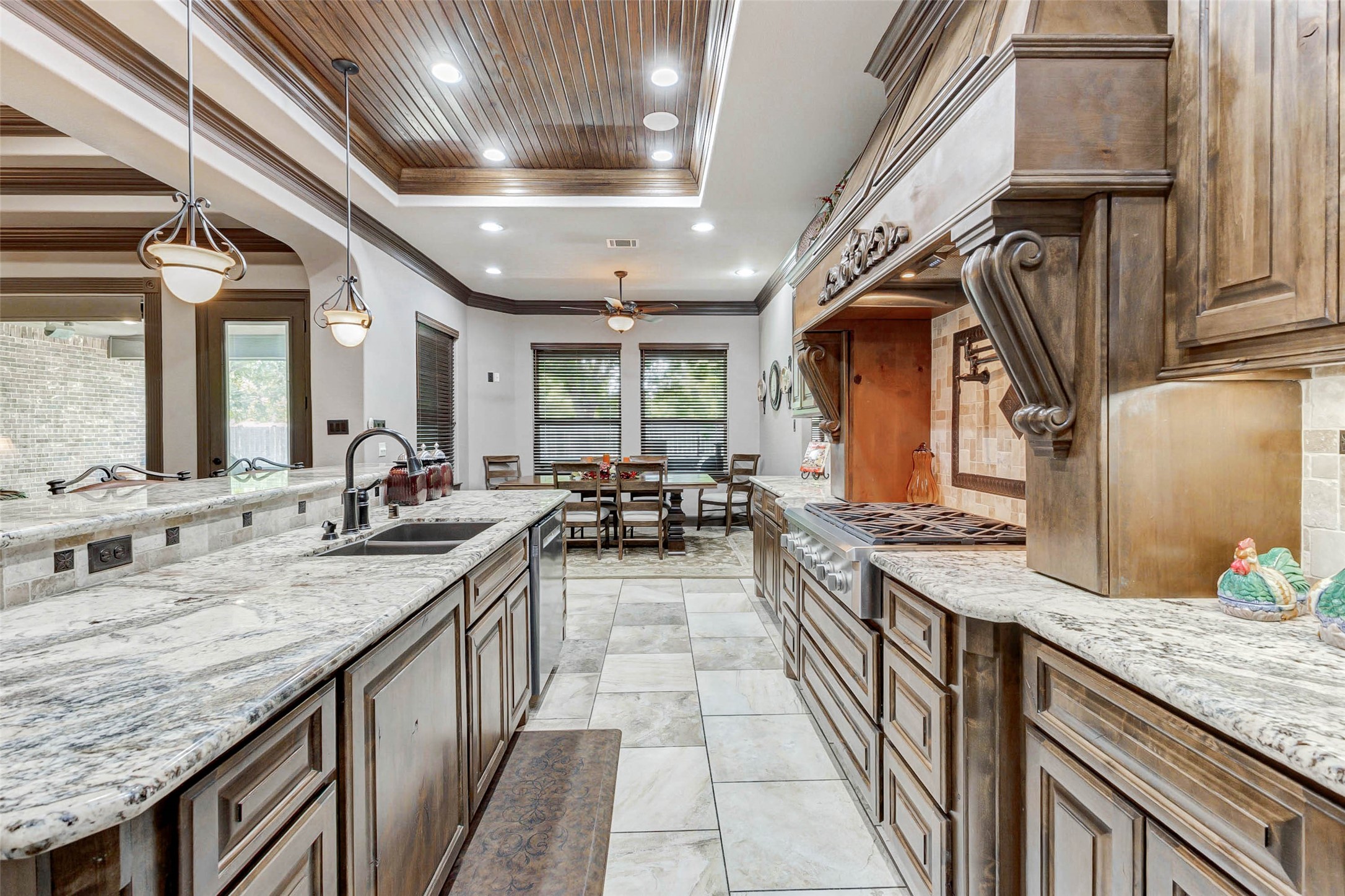 4315 Wickby Street Fulshear, TX 77441 - Photo 16 of 46 a large kitchen with stainless steel appliances granite countertop plenty wooden cabinets