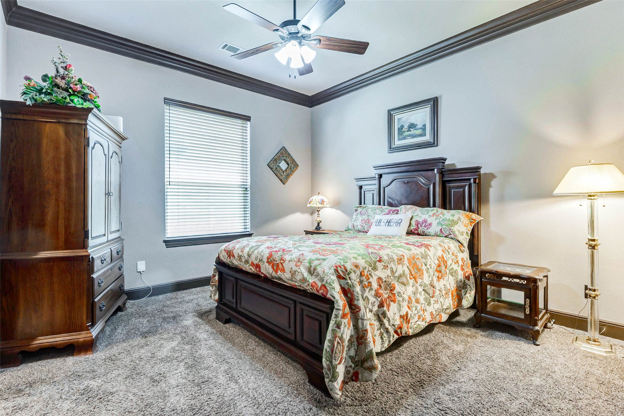 4315 Wickby Street Fulshear, TX 77441 - Photo 23 of 46 a bedroom with a bed chandelier and a window