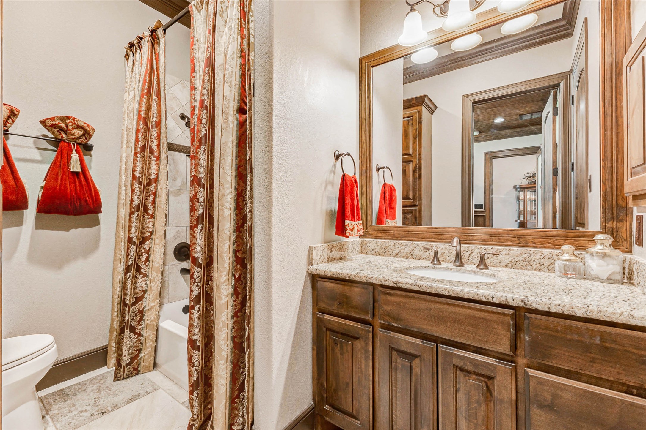 4315 Wickby Street Fulshear, TX 77441 - Photo 24 of 46 a bathroom with a granite countertop sink and a mirror