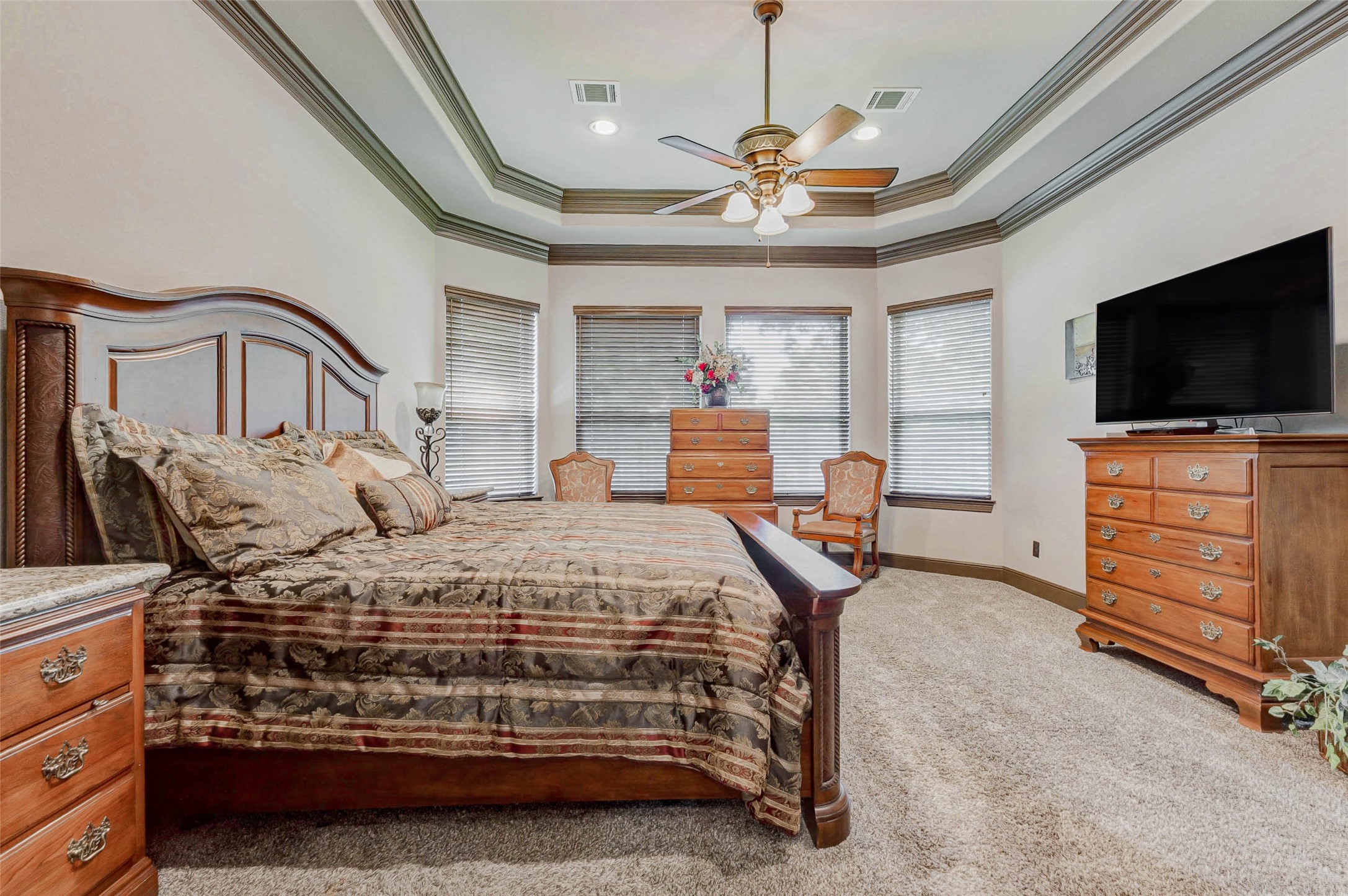 4315 Wickby Street Fulshear, TX 77441 - Photo 28 of 46 a bedroom with a bed and a flat screen tv