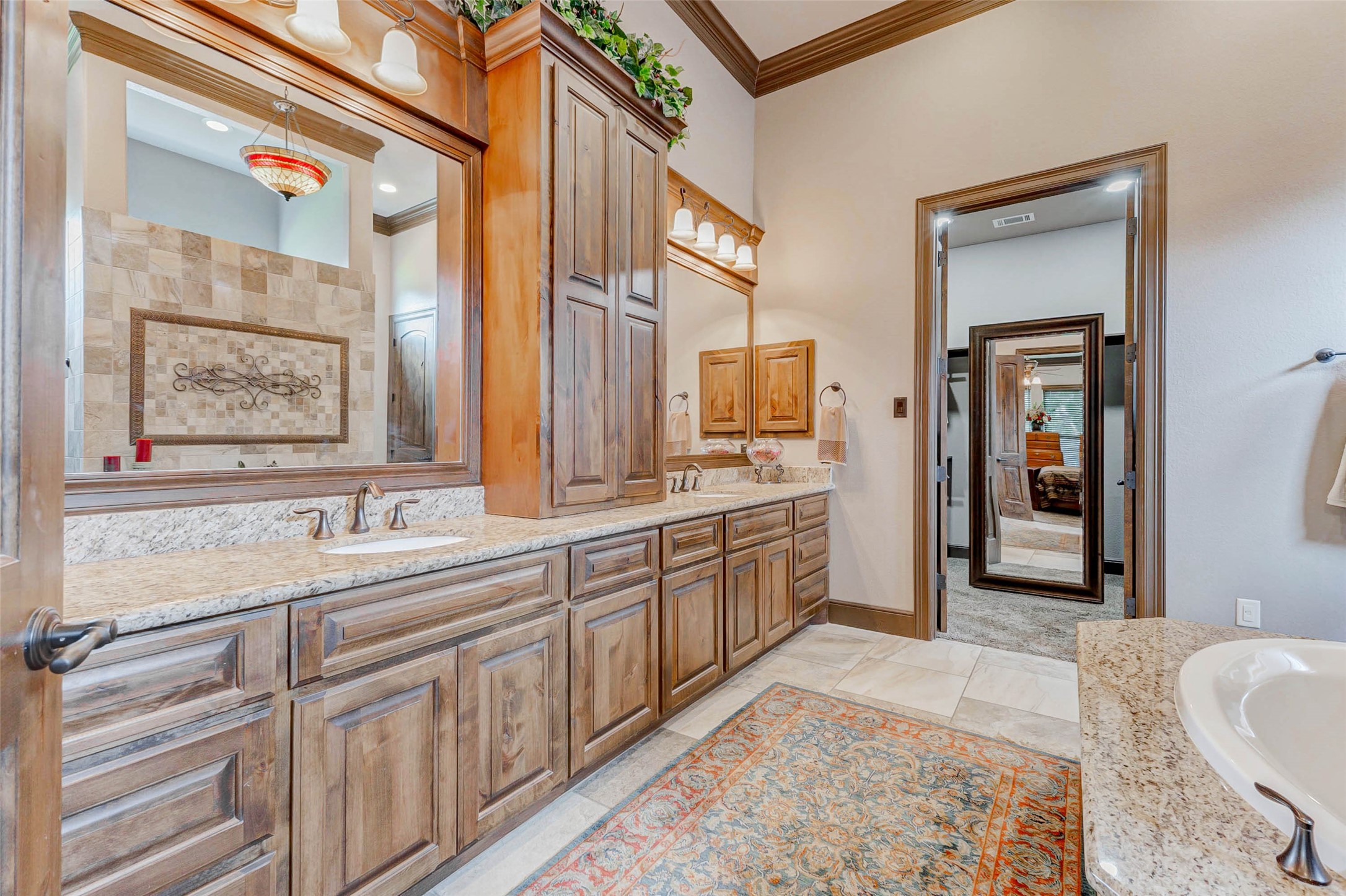 4315 Wickby Street Fulshear, TX 77441 - Photo 29 of 46 a large bathroom with a double vanity sink a mirror and a bathtub