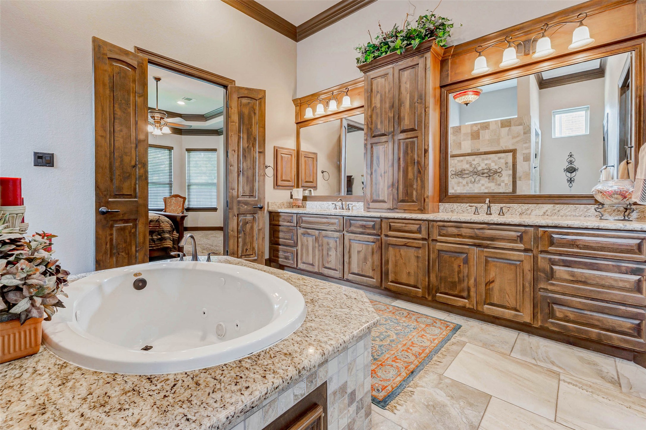 4315 Wickby Street Fulshear, TX 77441 - Photo 30 of 46 a bathroom with a tub sink and mirror