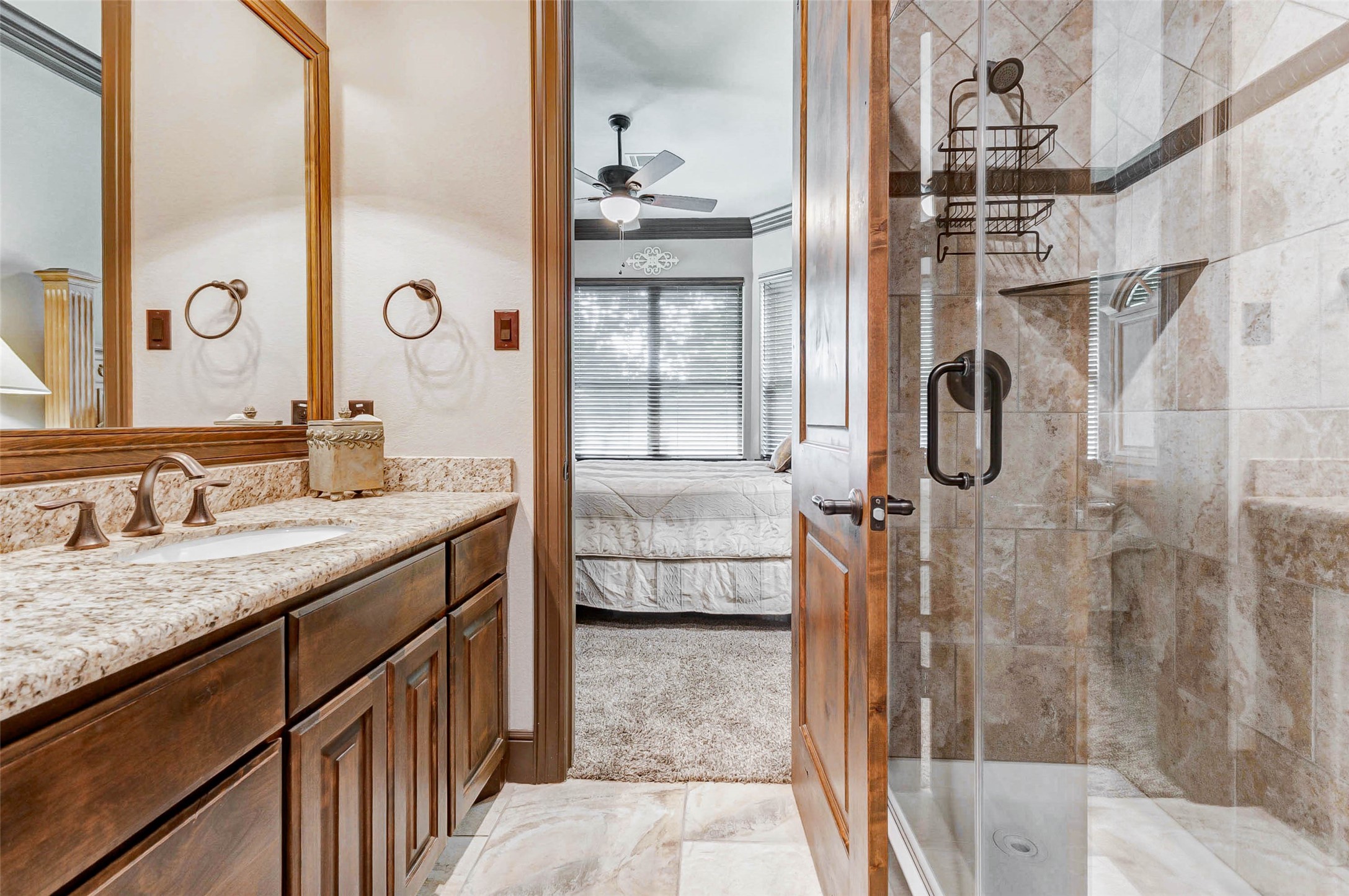 4315 Wickby Street Fulshear, TX 77441 - Photo 39 of 46 a bathroom with a granite countertop shower sink and mirror