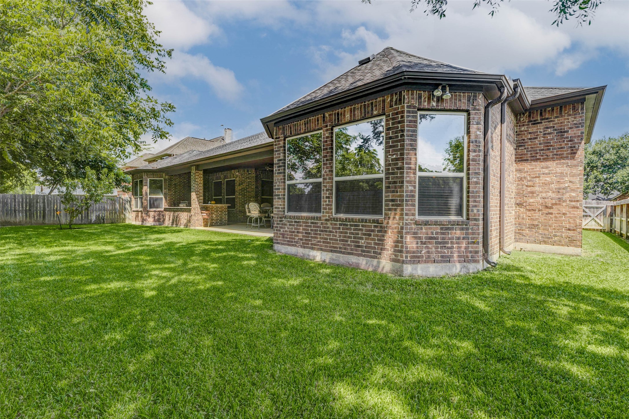 4315 Wickby Street Fulshear, TX 77441 - Photo 44 of 46 a front view of a house with a garden