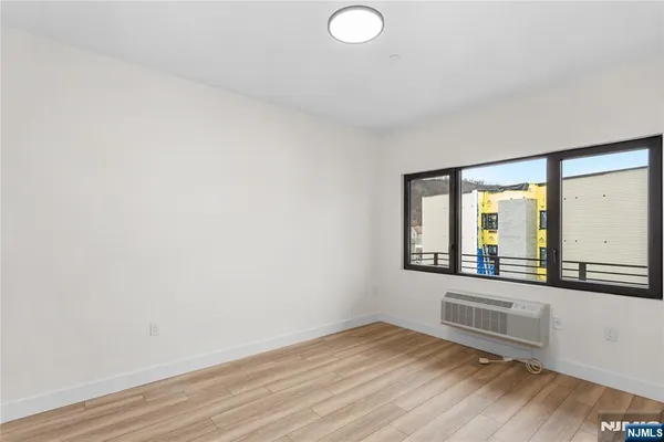a view of a room with wooden floor and windows