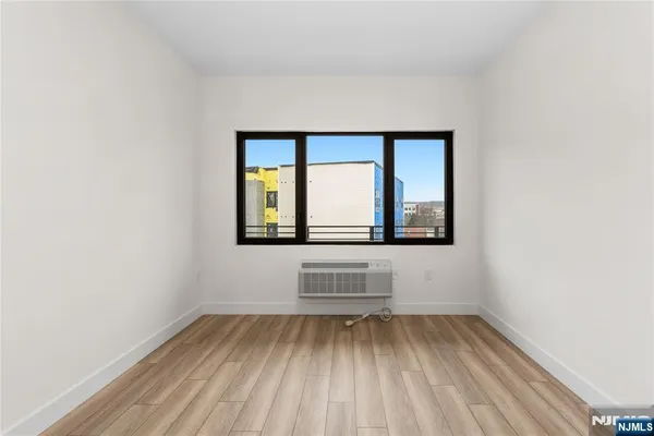 a view of wooden floor and a window in a room