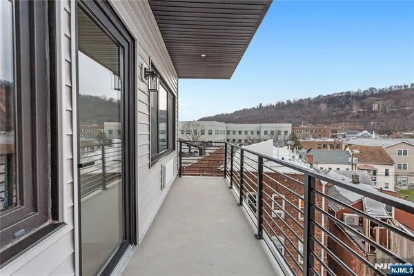 a view of an empty room with a cabinet and mirrors