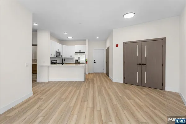 a view of a kitchen with wooden floor and a sink