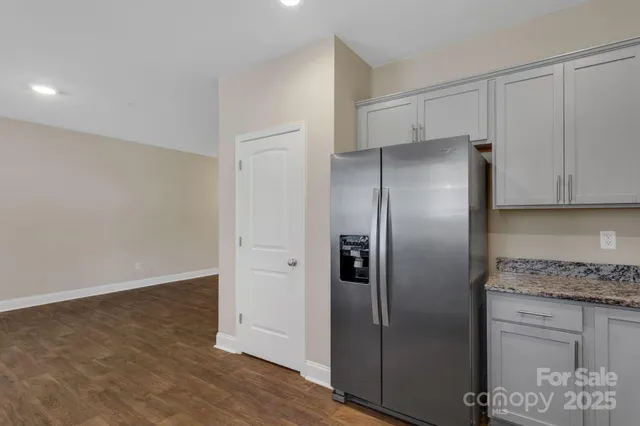 a kitchen with a refrigerator and cabinets