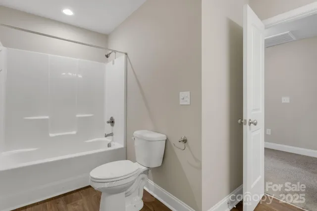 a bathroom with double sink and two mirror