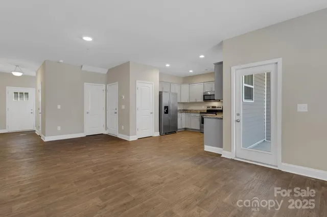 a view of a kitchen with refrigerator and a sink