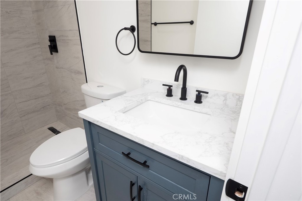 1571 Ricardo Street Los Angeles, CA 90033 - Photo 25 of 29 a bathroom with a sink a toilet and shower curtain
