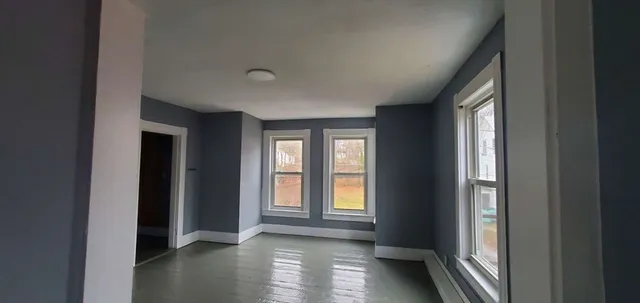 a view of hallway with windows and chandelier