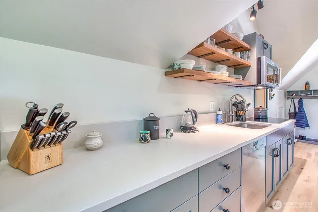 a kitchen with a sink a stove and cabinets
