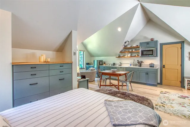 a kitchen with a table chairs refrigerator and microwave