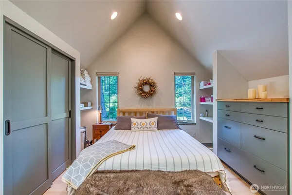 a bedroom with a large bed and a dresser