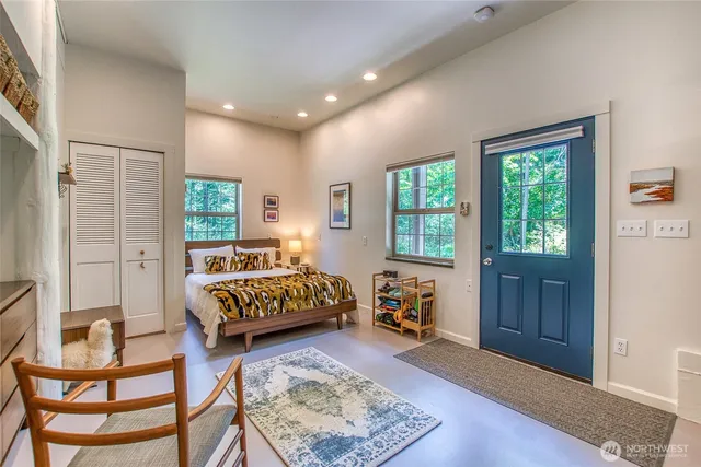 a bedroom with a bed and wooden floor
