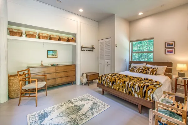 a bedroom with furniture and a window