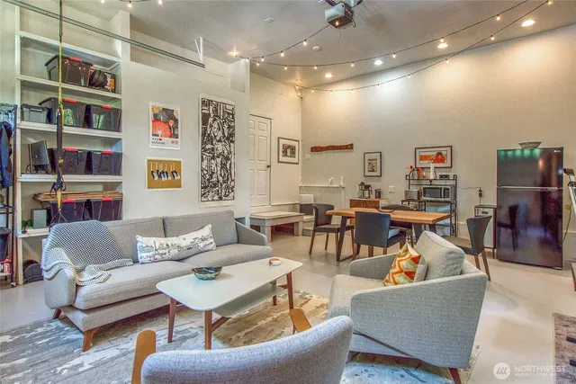 a living room with furniture and a book shelf