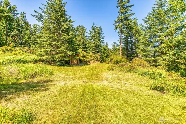 a view of a small house with a yard