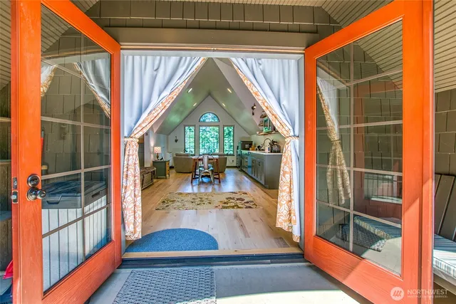 a view of entryway and hall with wooden floor