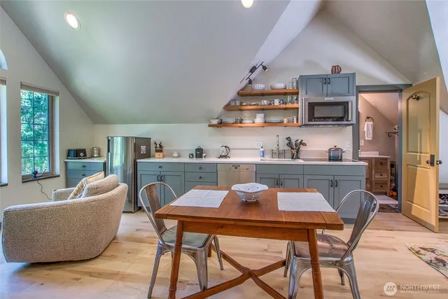 a dining room with furniture and wooden floor