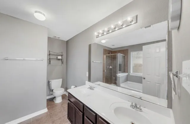 a bathroom with a sink double vanity and a mirror