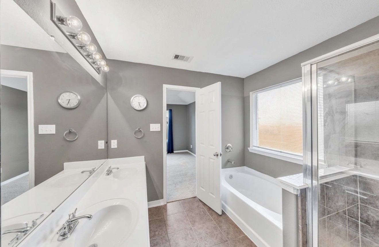 9807 Onyx Trail Drive Rosharon, TX 77583 - Photo 13 of 24 a en suite bathroom with a tub shower and a sink