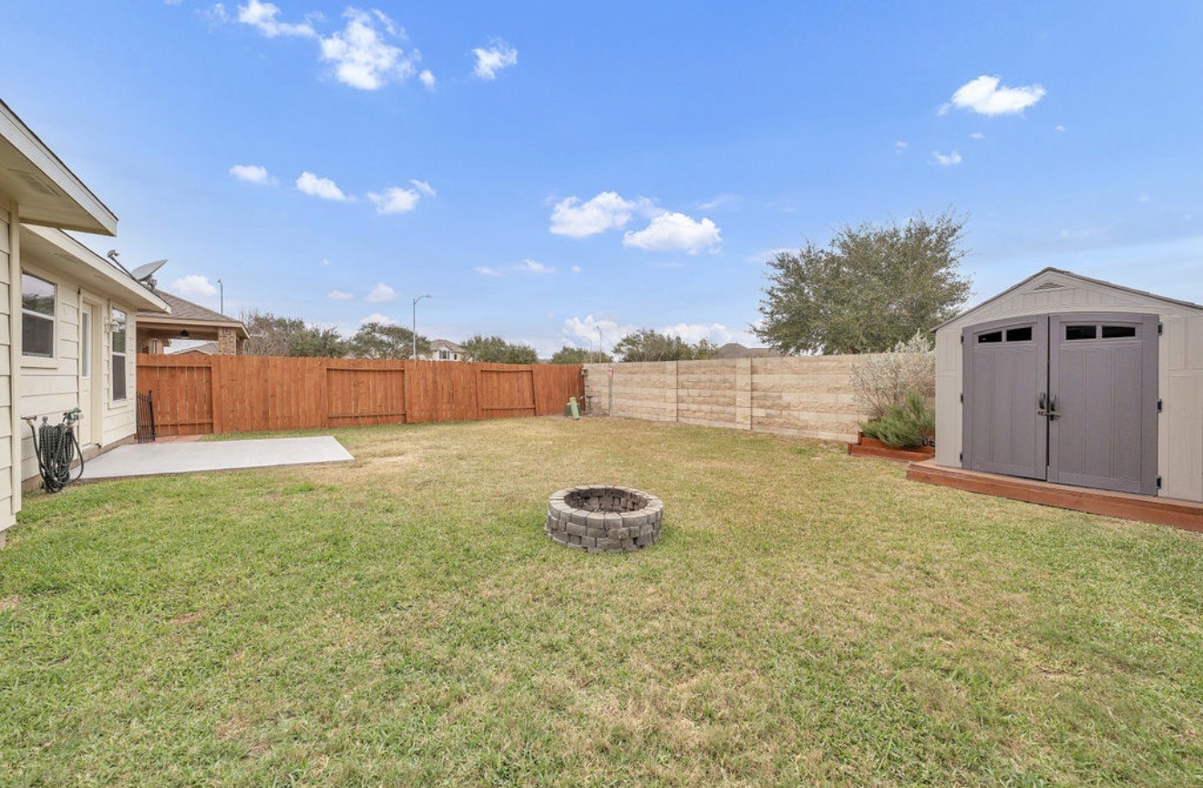 9807 Onyx Trail Drive Rosharon, TX 77583 - Photo 23 of 24 a backyard of a house with a yard and outdoor seating
