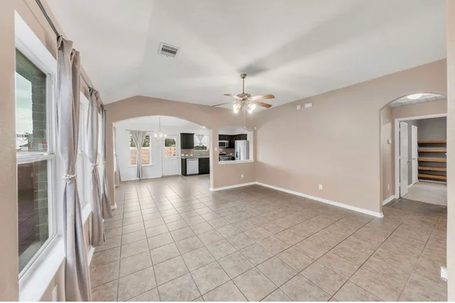 a view of a kitchen with furniture and an empty room
